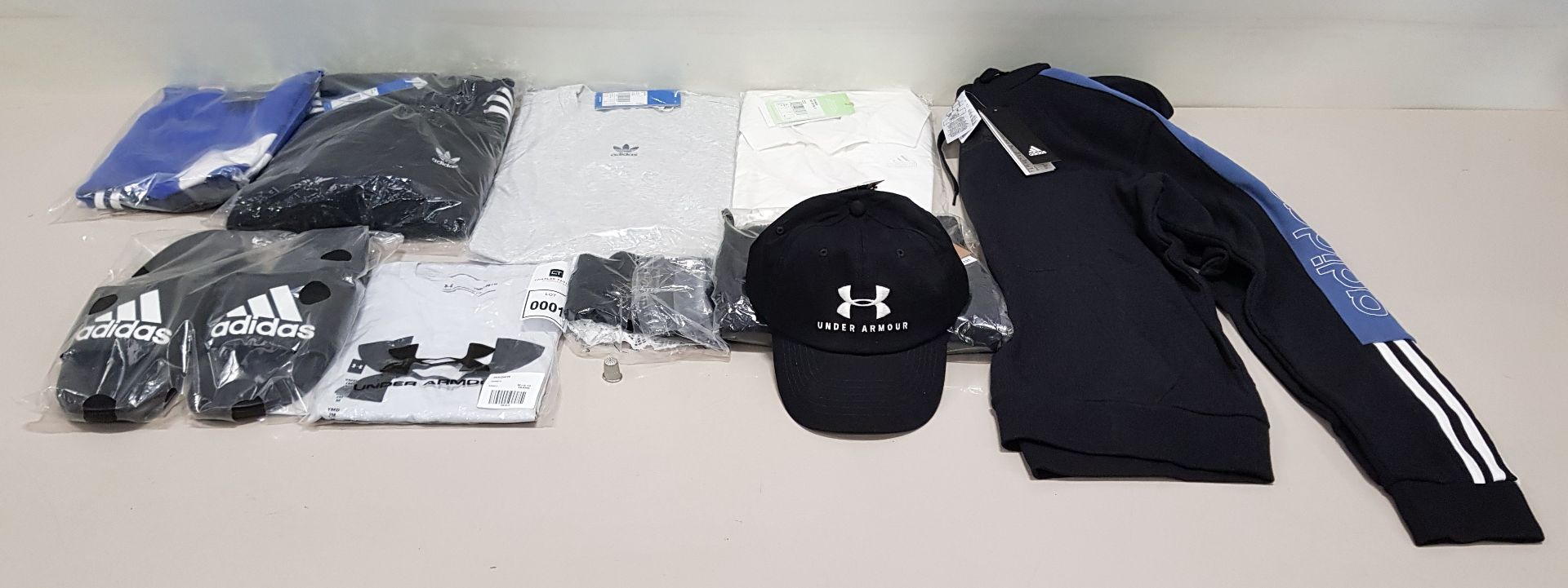 10 PIECE CLOTHING LOT CONTAINING AN UNDER ARMOUR HAT, ADIDAS SLIDERS, UNDER ARMOUR T SHIRT AND AN