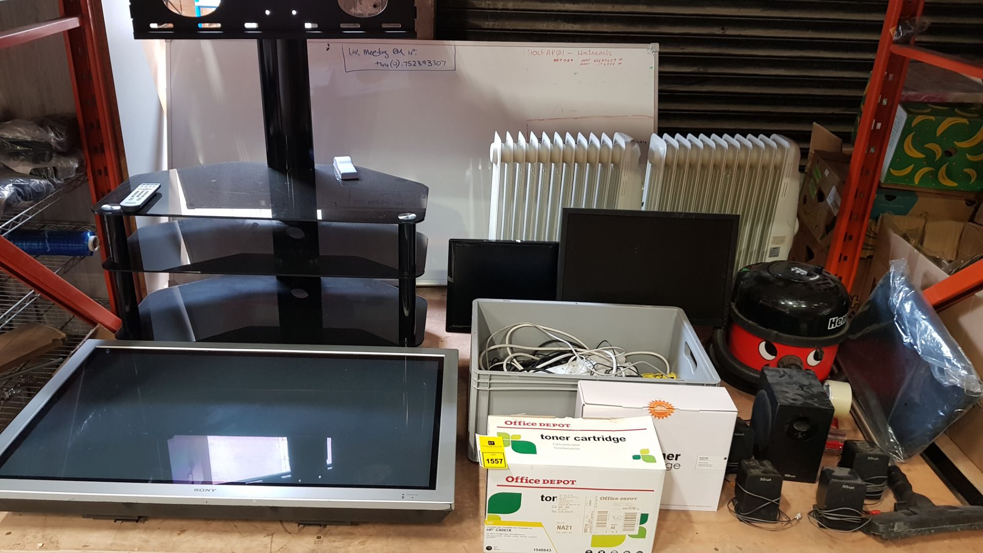 ASSORTED LOT CONTAINING TV STAND, TV, RADIATOR, OFFICE DEPOT TONER CARTRIDGE, MONITORS, SPEAKER,