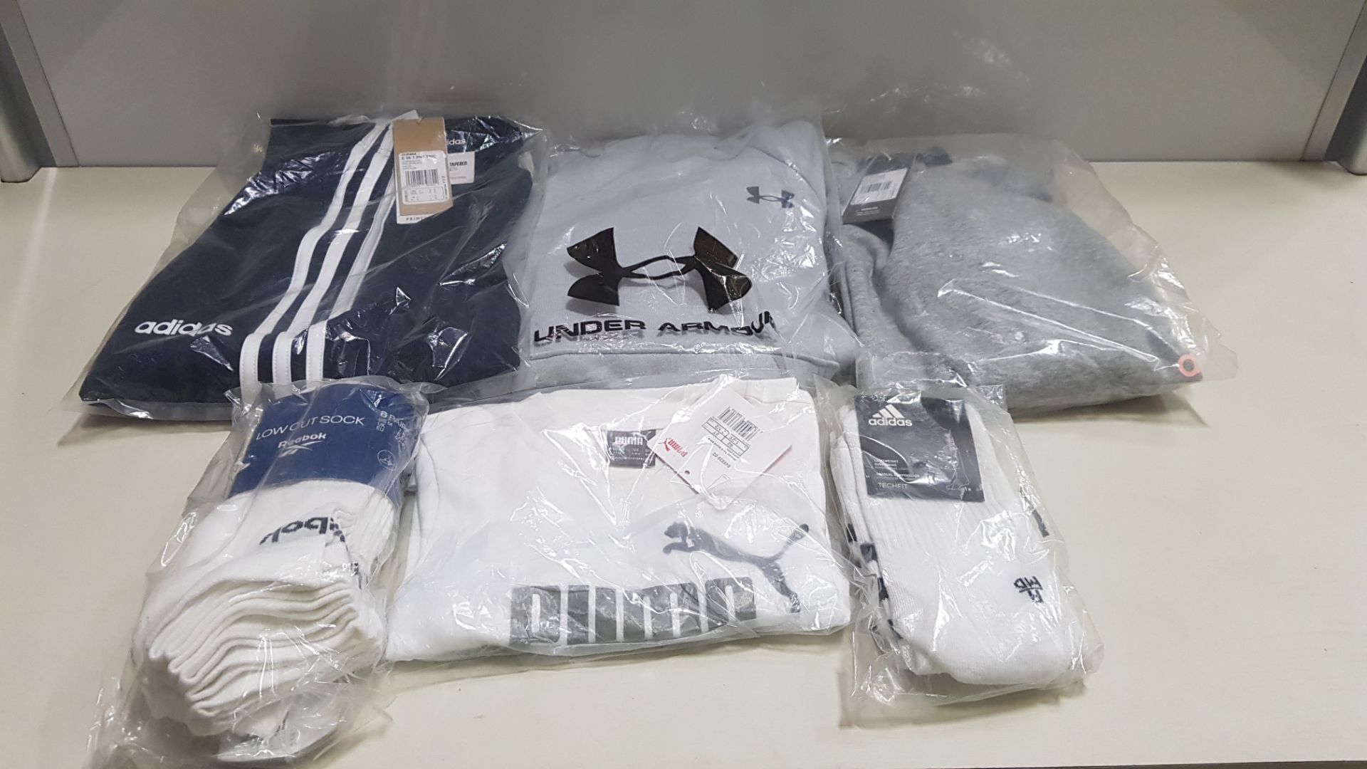 16 PIECE MIXED SPORTS CLOTHING LOT CONTAINING REEBOK JACKET, UNDER ARMOUR HOODED JUMPER, ADIDAS