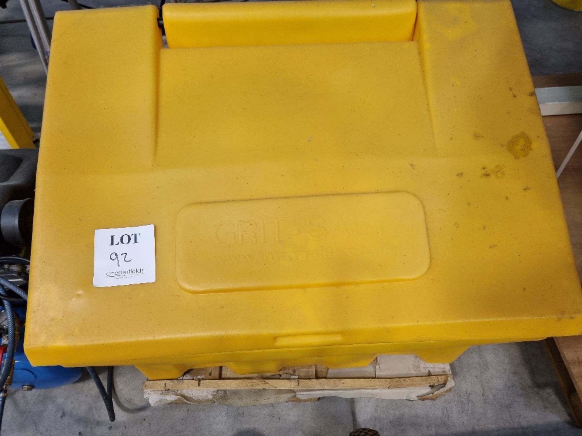 Yellow grit bin comprising bags of rock salt