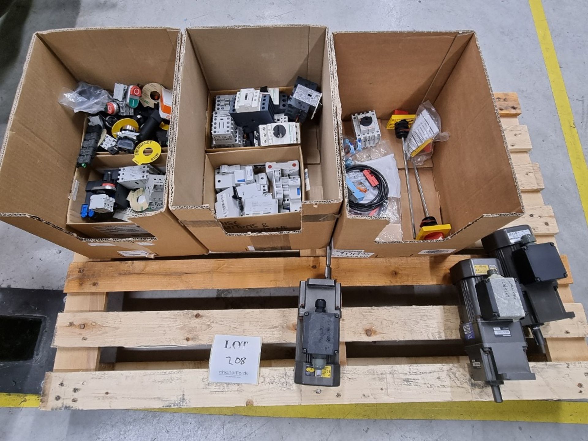 A pallet containing 3 - 90 watt Panasonic gear motors and boxes of contact breakers, switches,