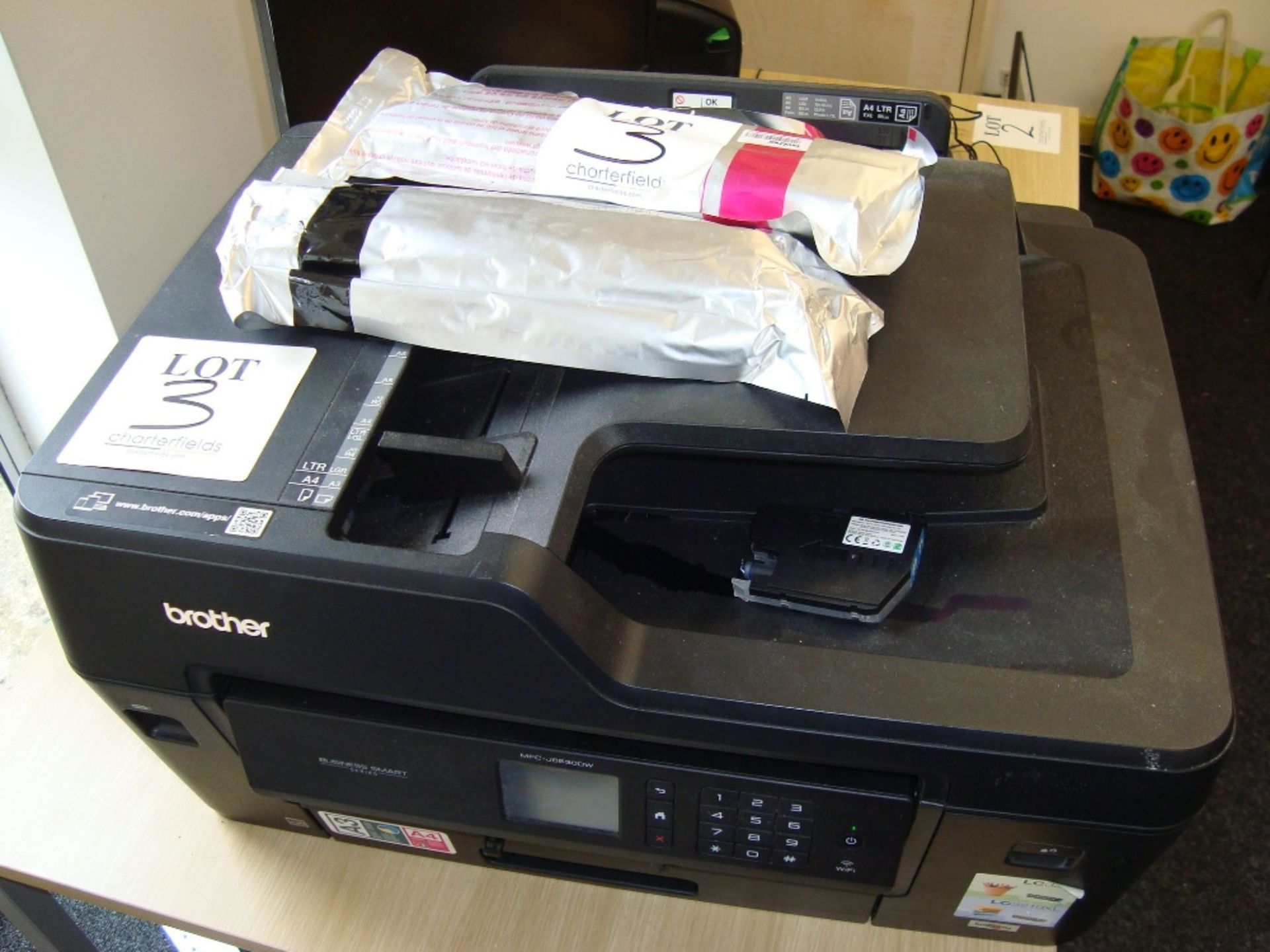 A Brother MFC-J6530DW multi function printer with spare ink cartridges as lotted