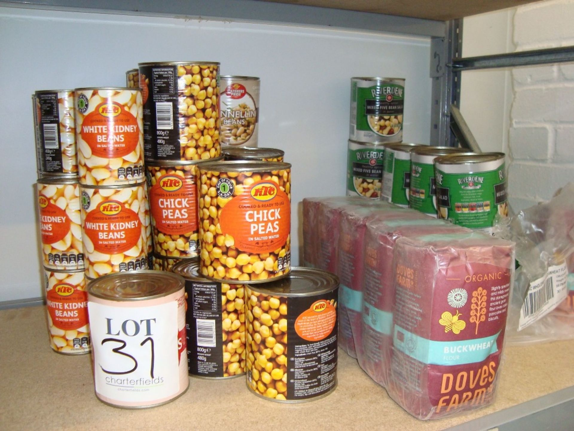 A quantity of non-perishable food stock including canned vegetables, flour, coconut milk, pasta,