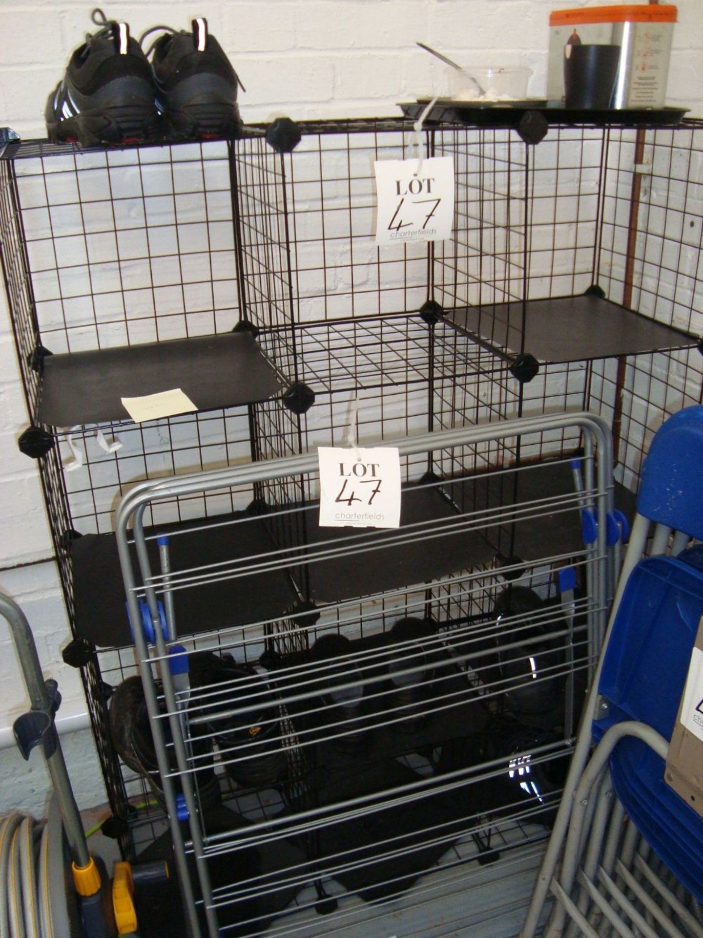 A steel framed folding clothes drying rack and a wire framed shoe rack