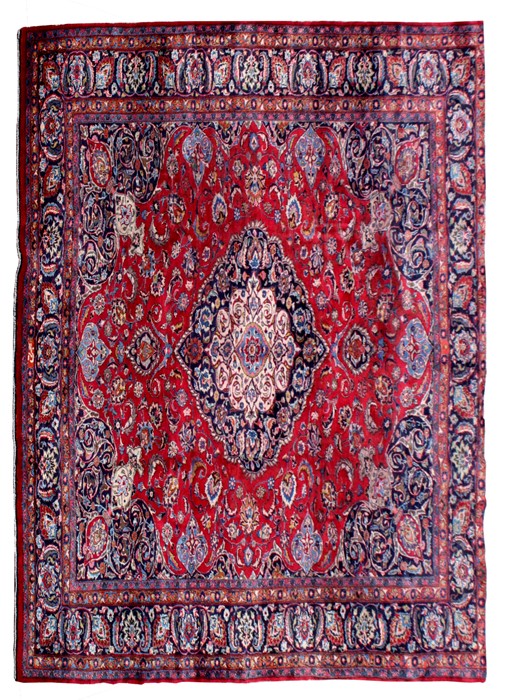 A Persian Mashad woollen hand knotted carpet with central floral medallion within floral borders