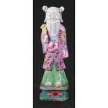 An 18th / 19th century Chinese famille rose figure in the form of a robed Immortal holding a fan,