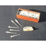 A set of bone faced Dominoes and a set of six Egyptian bone Cocktail Sticks with holder