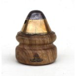 A WW1 trench art fuse mounted on a turned hardwood base paperweight with applied gilt and enamel