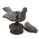 An 18th century bronze figure in the form of a dove mounted on a plinth, 11cms (4.25ins) high.