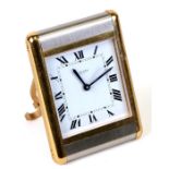 A Cartier brushed steel and brass travel alarm clock, 7.5cms (3ins) wide.Condition Reportsome