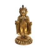 A Chinese gilded bronze standing robed Buddha figure, 33cms (13ins) high.