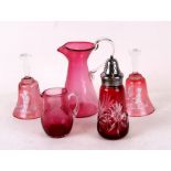 A pair of Mary Gregory style cranberry glass hand bells, 15cms (6ins) high; together with two