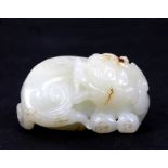 A Chinese jade figure of a recumbent temple lion, 5cms (2ins) long.Condition ReportGood condition