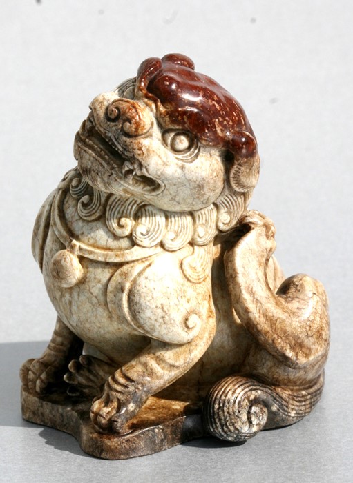 A Chinese figured jade / hardstone temple lion, 10cms (4ins) high.