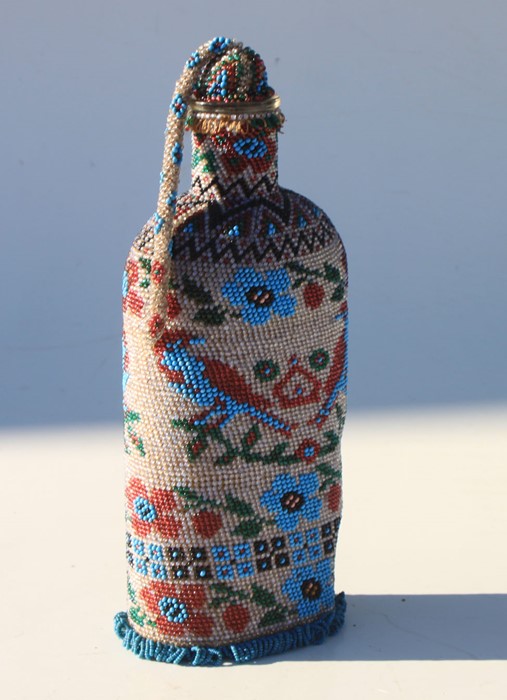 A Boer War 1901 dated Prisoner of War art bead covered bottle with stopper. Overall height 23cms (