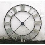 A large steel decorative clock face with Roman numerals, 122cms (48ins) diameter.