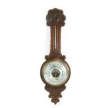 An early 20th century oak cased barometer thermometer by Gamage of London, 79cms (31ins) high.