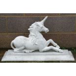 A concrete unicorn on a plinth base, 88cms (33ins) wide.