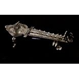 An Indian white metal box in the form of a sitar, 17.5cms (7ins) long.