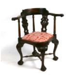 A Georgian style corner chair on cabriole legs with ball & claw feet.