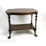 A 19th century mahogany two-tier occasional table on turned supports and lion paw feet, 87cms (34.