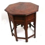 A Moroccan Moorish hardwood occasional table, the octagonal top inlaid with brass and ebony,