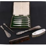 A cased set of silver handled knives together with silver handled shoe horns and other items.