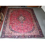 A fine Persian Kashmar woollen hand knotted carpet with central medallion within floral borders on a