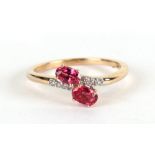 A 9ct gold ring set with two oval pink stones and eight small diamonds, approx UK size 'N', 2.1g.