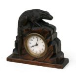 A late 19th / early 20th century carved wooden mantle clock in the form of a lizard climbing over