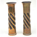 A matching pair of trench art 1943 dated brass shell cases with spiral twist decoration and engraved