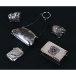 A silver purse with engraved foliate decoration, a silver vesta, a silver matchbox cover and two