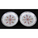 A pair of Chinese shallow dishes decorated with foliate scrolls, blue seal mark to the underside,