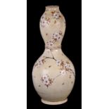 A Japanese Satsuma double gourd vase decorated with prunus on a cream ground, four character red