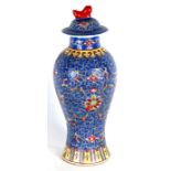 A Chinese vase & cover decorated with butterflies and foliate scrolls, 25cms (9.75ins) high.