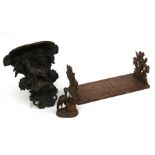 A Black forest wall bracket, a similar sliding bookrack and and inkwell (3)Condition