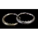 A pair of Asian white metal (not tested) bangles, 8cms (3.1ins) diameter (2).