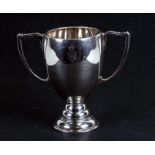 A silver two-handled trophy cup with presentation inscription 'Presented by H M the King Through his