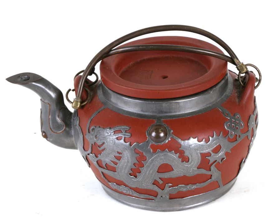 A Chinese Yixing teapot with pewter overlay decorated dragons, Tung King Shun Factory in Weihaiwei