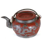 A Chinese Yixing teapot with pewter overlay decorated dragons, Tung King Shun Factory in Weihaiwei