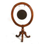 A Victorian brass gong in a circular oak frame on tripod base, the gong 30cms (12ins) diameter,