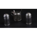 A matched set of silver condiments comprising salt and pepper pots, mustard pot and spoon, various