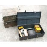 Three military metal trunks together with a gas mask, helmet and other items.