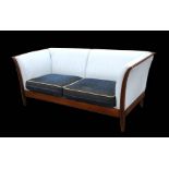 An Italian design Elle Salotti two-seater leather sofa with cloth cushions and mahogany frame,