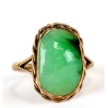 A 9ct gold ring set with an oval jade or hardstone cabochon, approx UK size 'M', 3.8g.