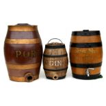 Three pottery barrels - Port, Gin and Sherry, the largest 40cms (15.75ins) high (3).