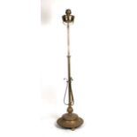 An Art Nouveau style brass oil standard lamp with adjustable column and stepped circular base,