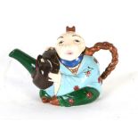 A majolica 'Mandarin' teapot and cover in the form of a seated Chinaman holding a mask with spout