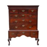 A Georgian figured mahogany chest on stand with three short drawers above three long graduated