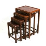 A nest of four Chinese Padouk tables, the largest 49cms (19ins) wide (4).